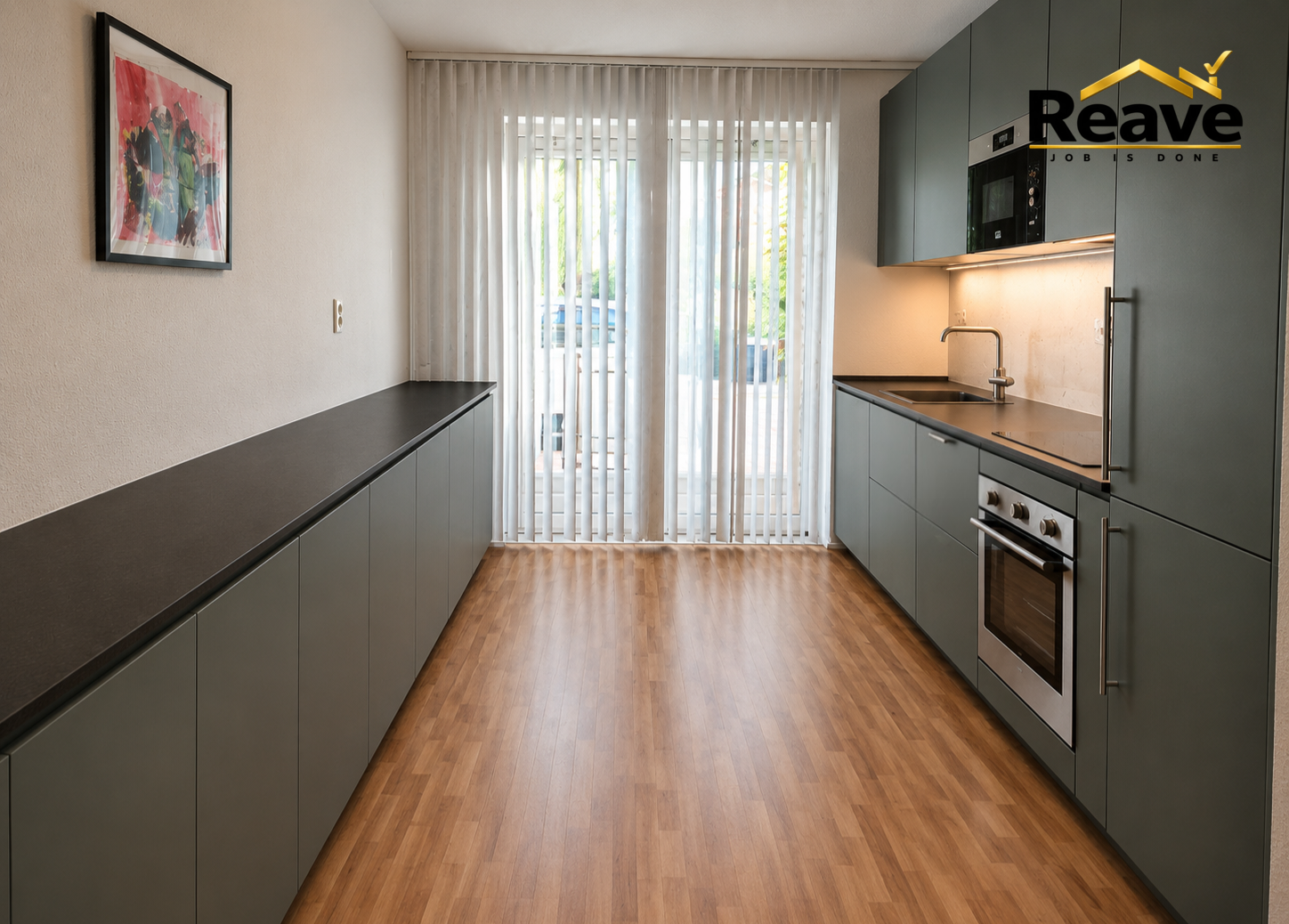 Forest green galley kitchen with black worktop and wood-effect flooring