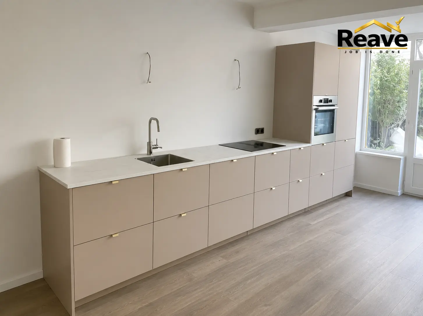 Long taupe kitchen run with brass handles and white worktop