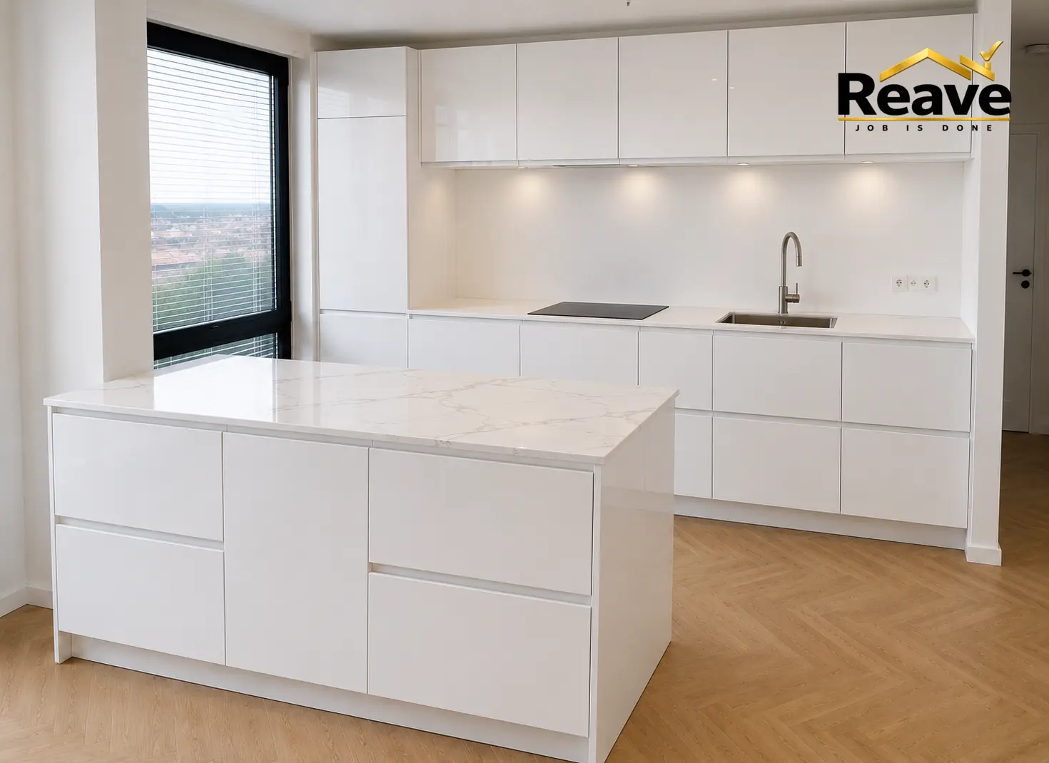High-gloss white kitchen with marble island and oak herringbone floor