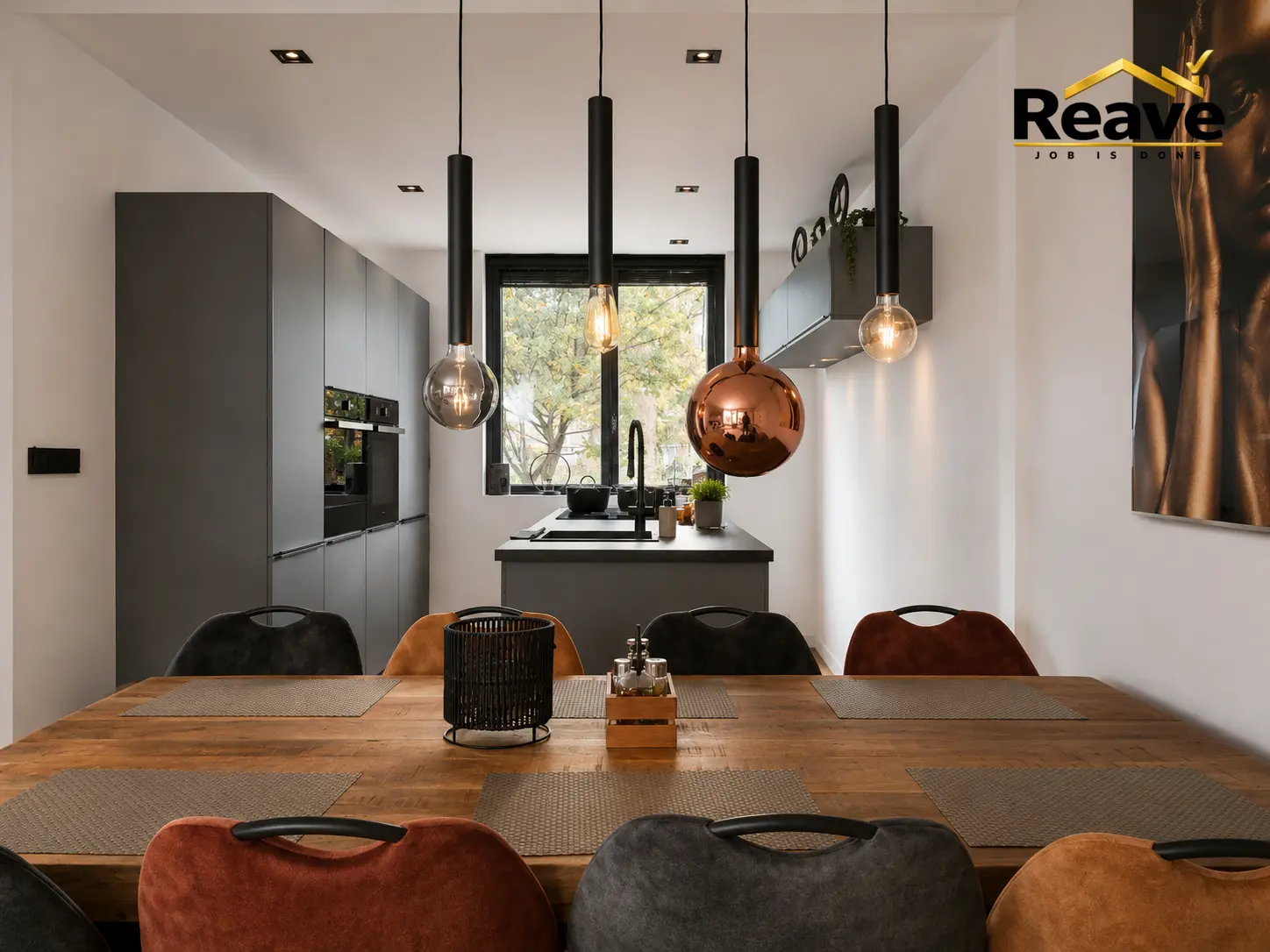 Grey handleless kitchen with island, black pendant lights and oak dining table