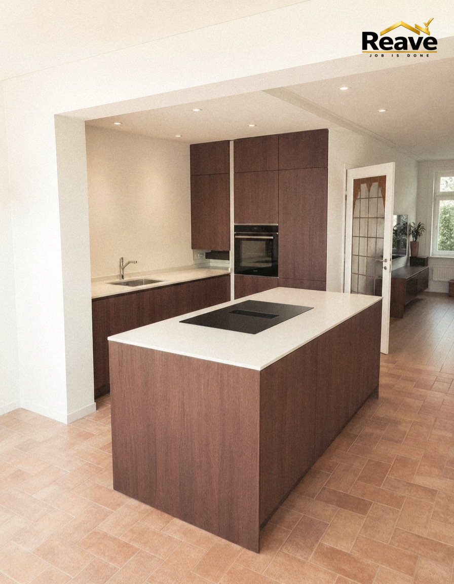 Dark walnut kitchen with large island, white worktop and terracotta tiled floor