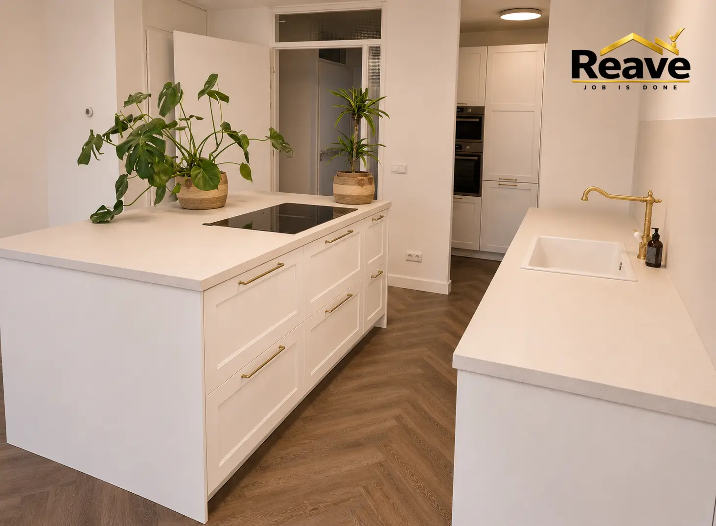 Cream kitchen island with brass tapware and herringbone wood floor
