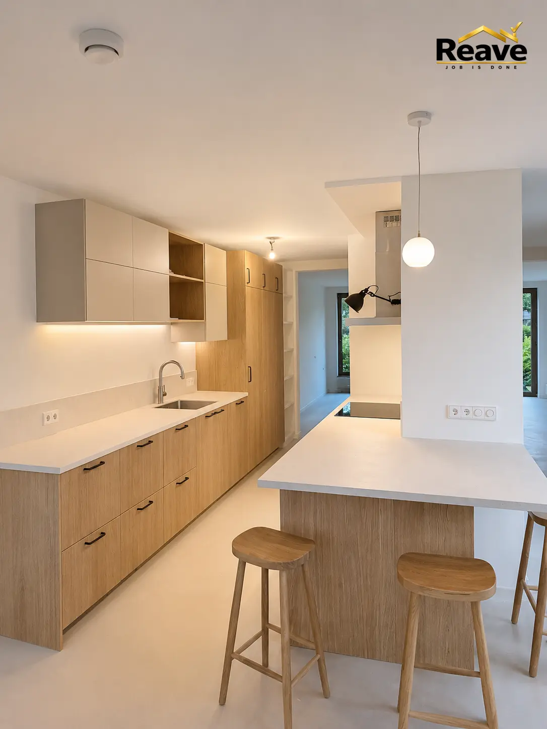 Light oak and cream kitchen with breakfast bar and wooden stools